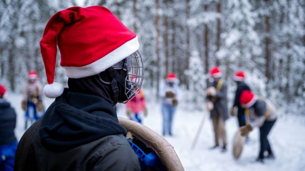 A recruit with a shield watches the group train in the snow